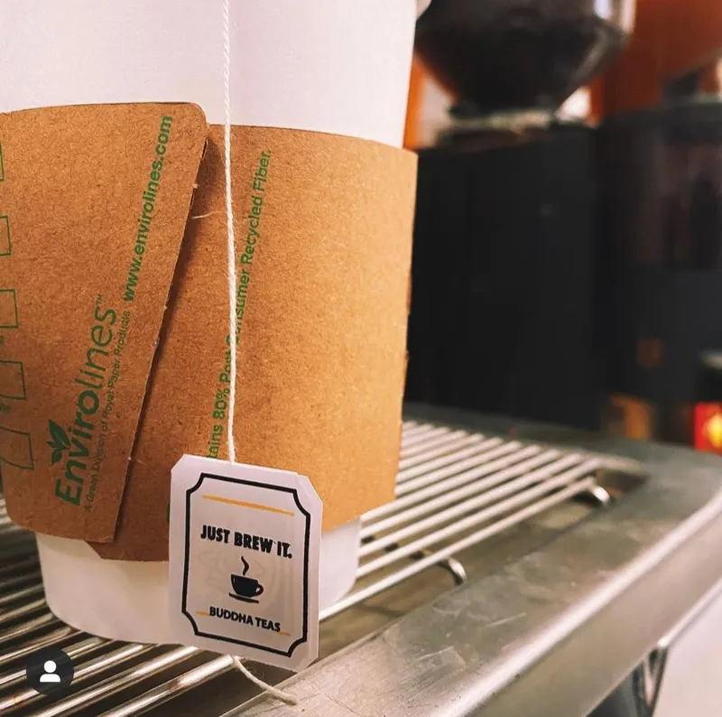 A to-go cup with a “Just brew it” tea tag